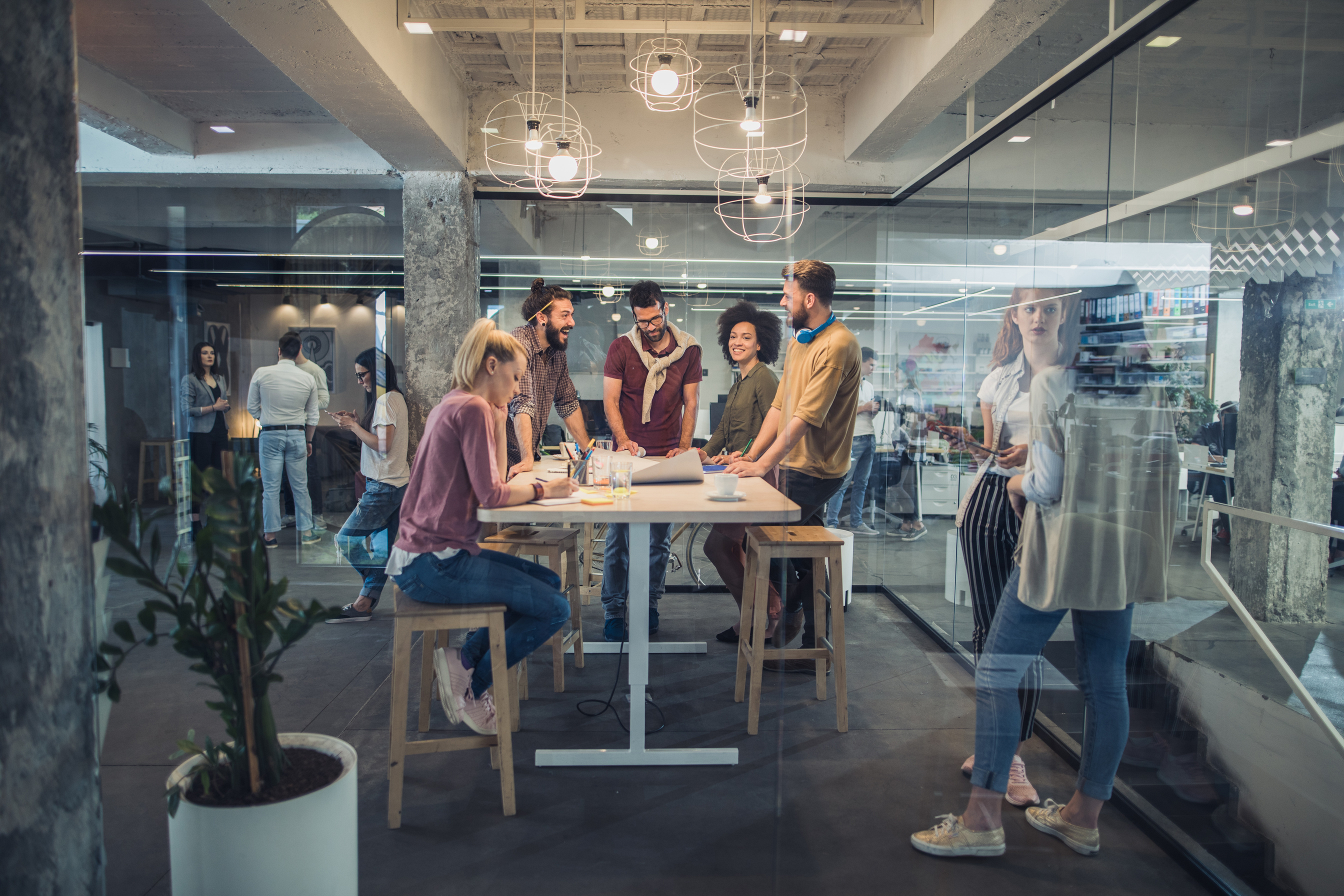Happy freelance workers communicating while working at corporate office.